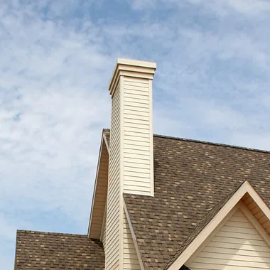 Finished chimney chase with new siding and a fitted chase cap